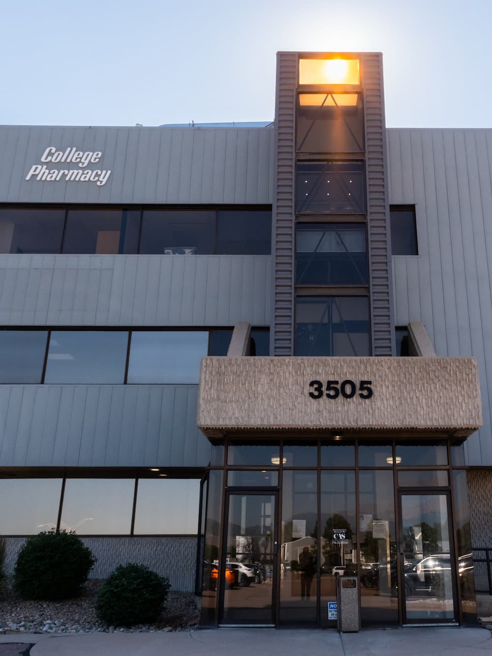 Exterior of the College Pharmacy building with the address 3505 above the main entrance.